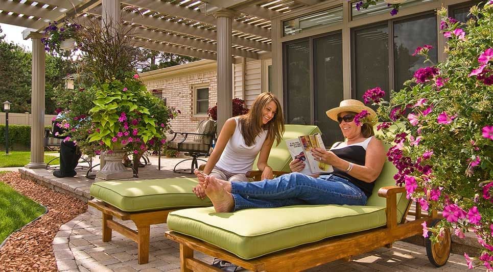 two women lounging on patio